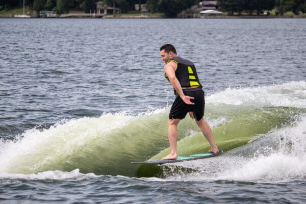 A man riding a surfboard on top of a wave.