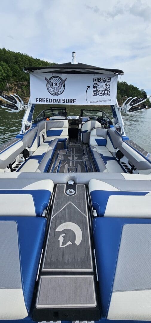 A boat with blue and white seats on the water.